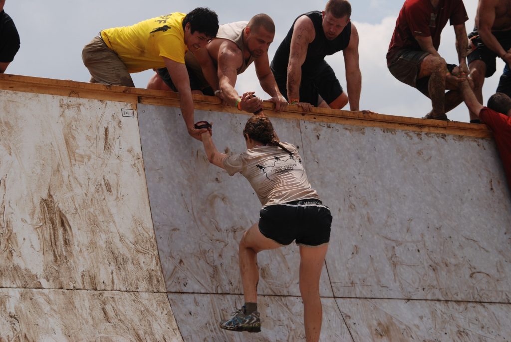 Woman climbing slope successfully